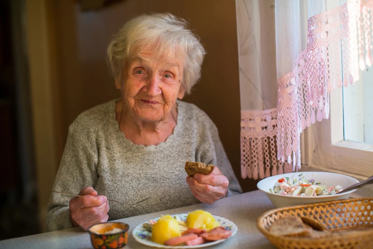 Senior woman enjoying a meal at home